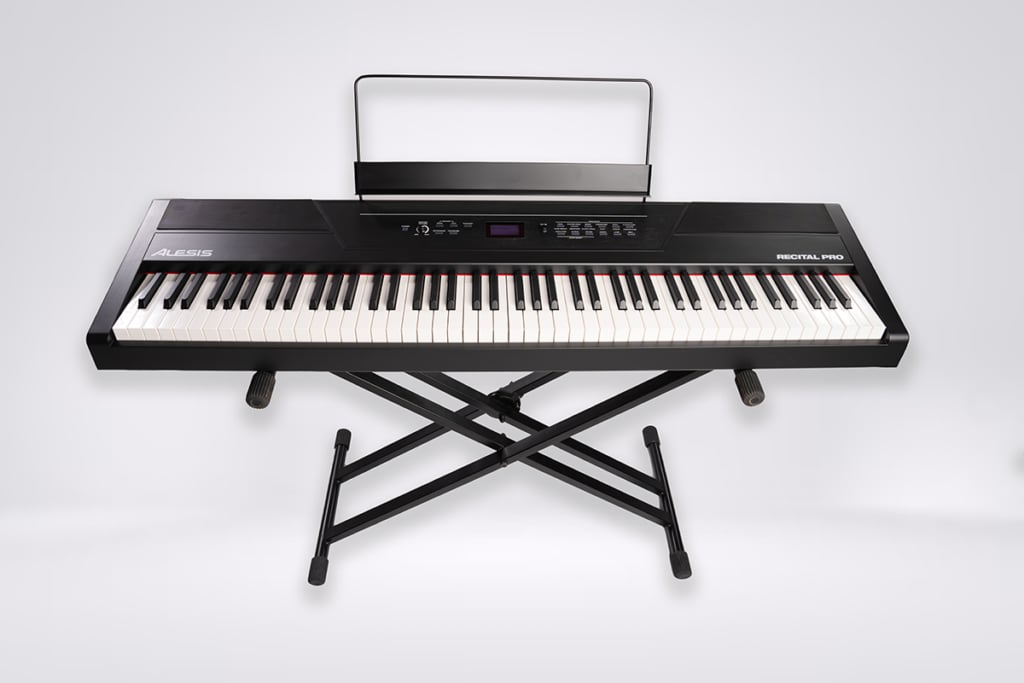 Black digital piano on stand with music stand.