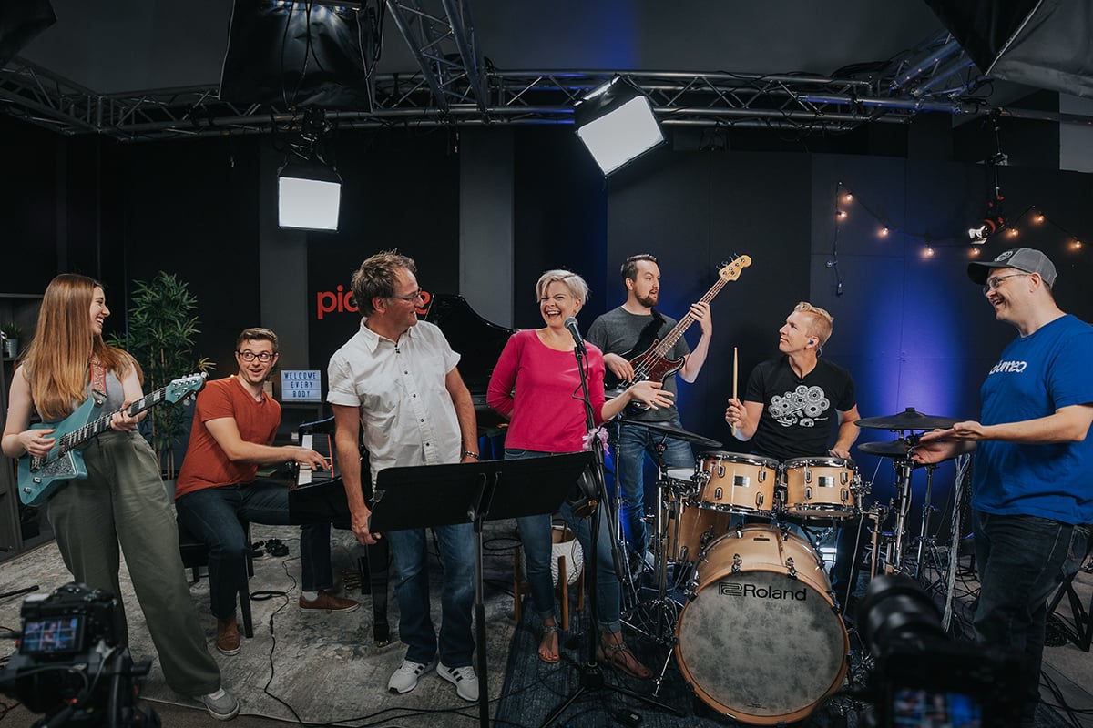 Pop piano songs - musicians in a studio including guitarist, pianist, singers, bassist, and drummer.