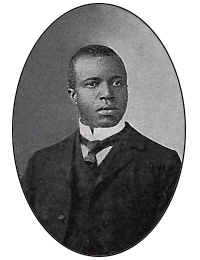 Composer of the entertainer, Scott Joplin. Black and white photo of a man in necktie and suit.